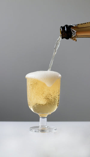 a bottle of champagne being poured into a glass