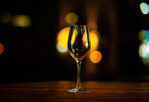 A wine glass sitting on top of a wooden table